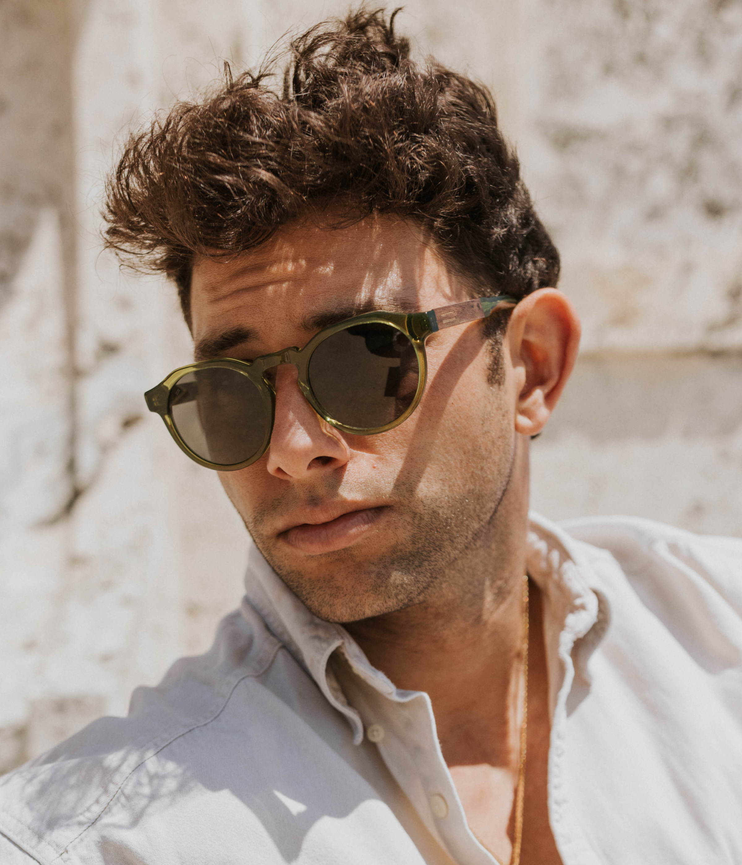 Anna Maria sunglasses with walnut wood and acetate worn at the Worth Avenue clock tower in Palm Beach