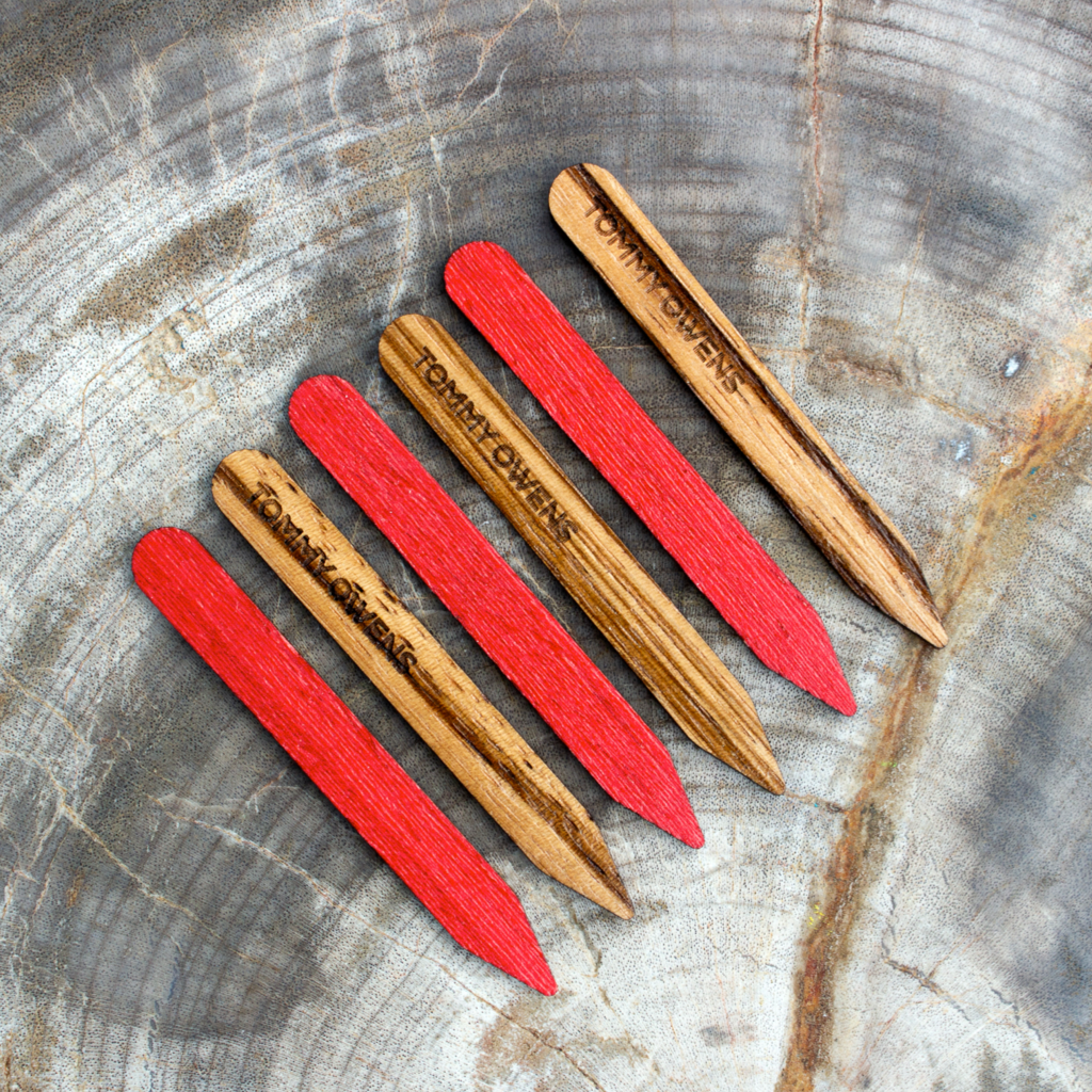Eye-catching zebrawood and red koto collar stays arranged in a dynamic pattern, highlighting the contrasting colors and unique grain.