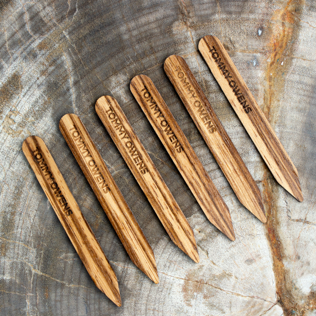 Exotic zebrawood collar stays lined up, showcasing their bold, striped grain pattern and handcrafted finish.