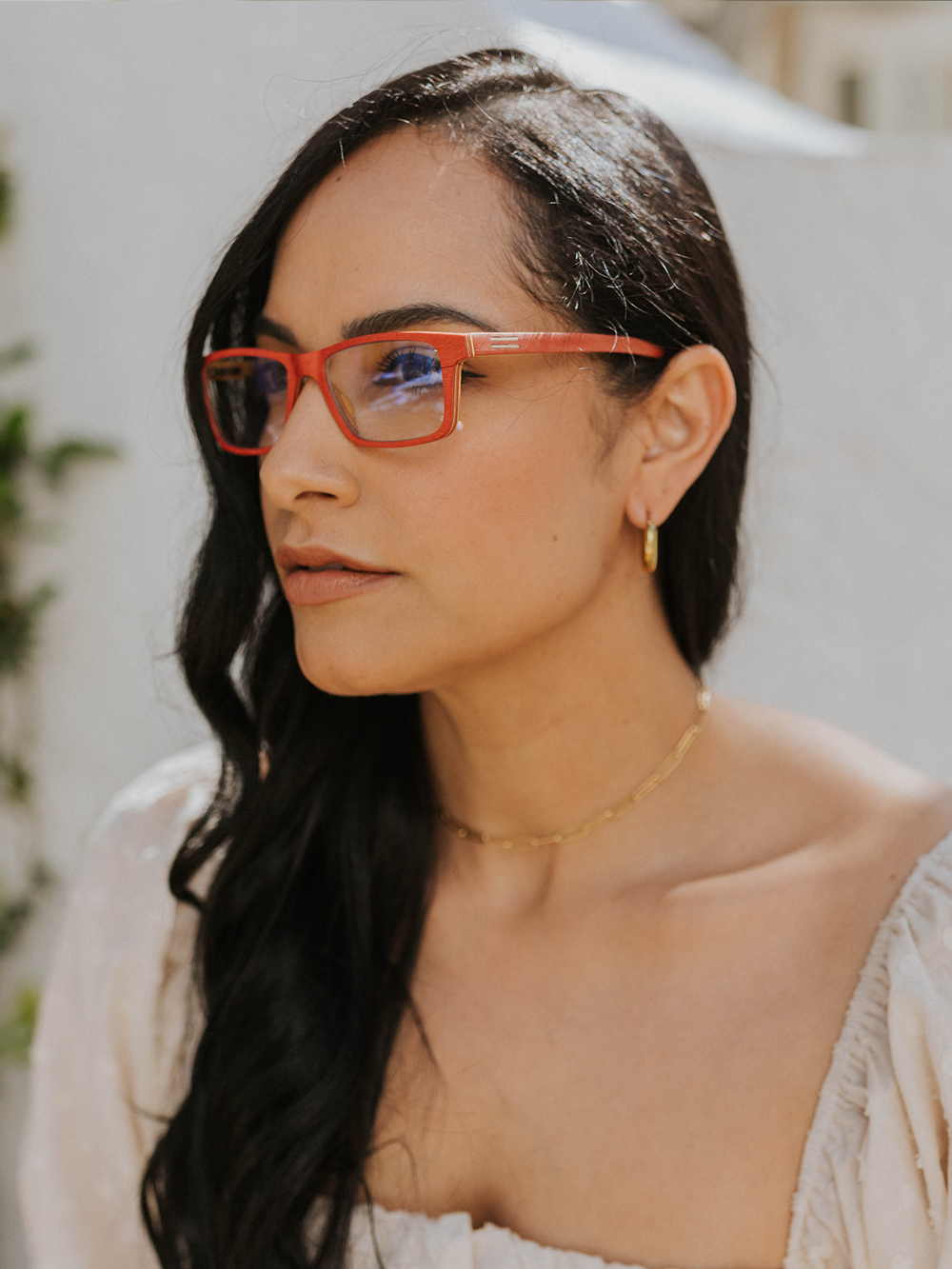 Red maple wood eyeglasses from the Total Wood Collection worn by woman in downtown Palm Beach courtyard