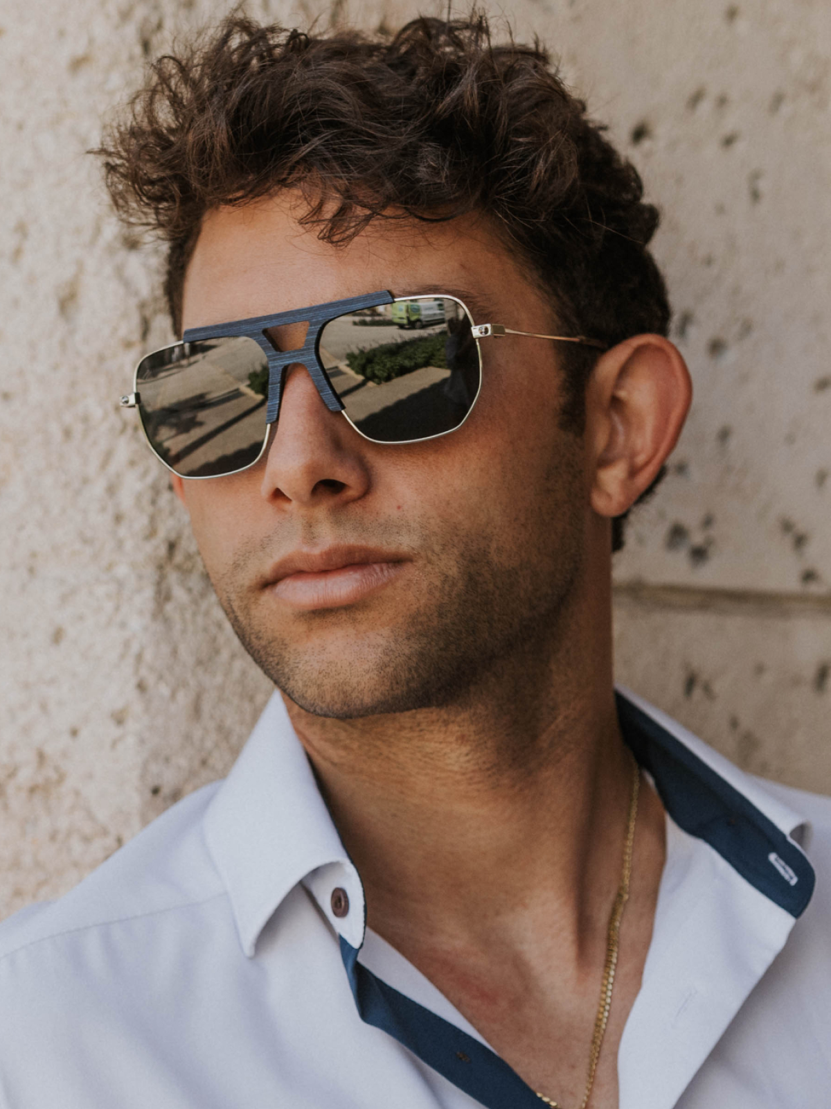 Hudson sunglasses with blue maple and acetate frames worn outdoors in a courtyard on Worth Avenue in Palm Beach