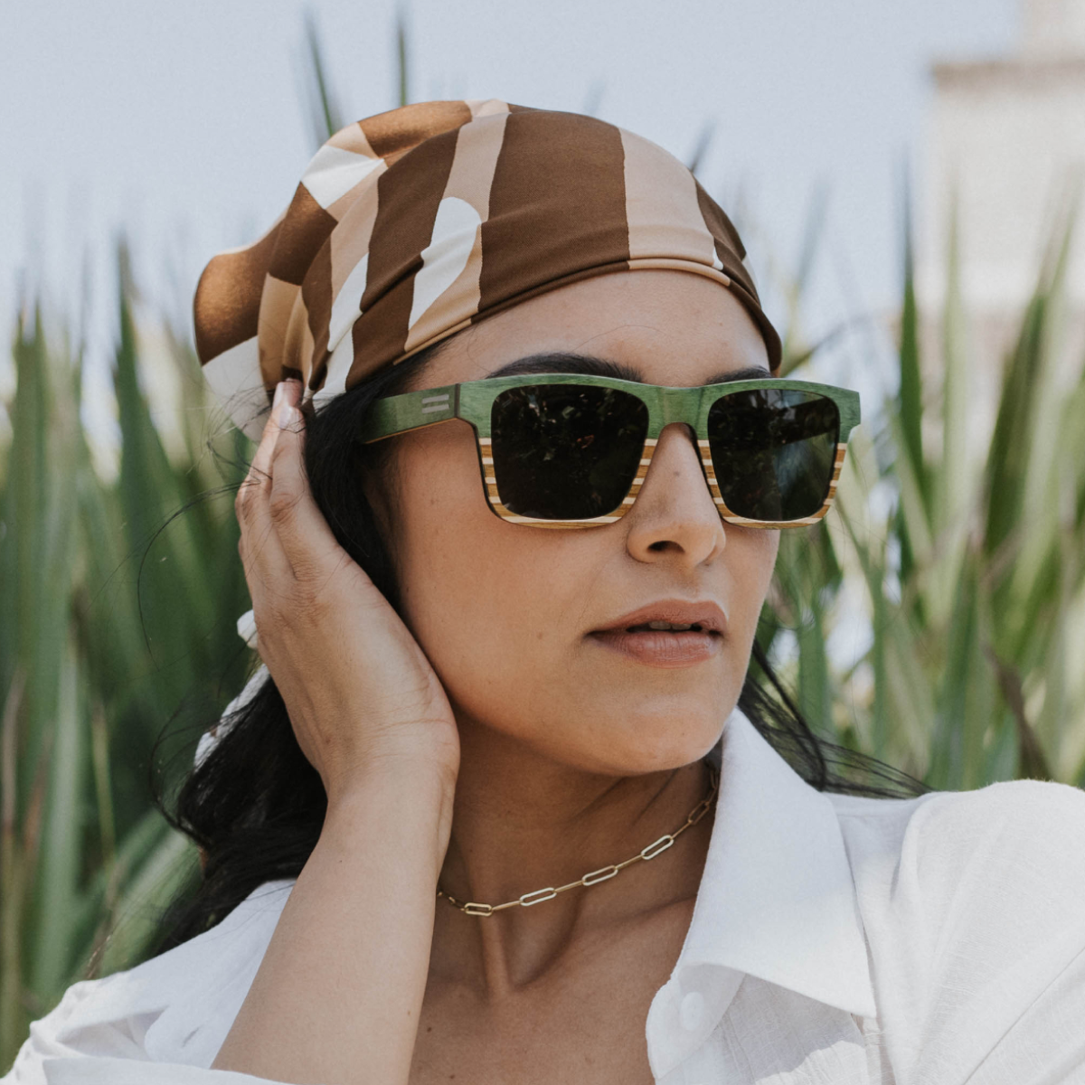 Sebastian Green Maritime Special Edition sunglasses in maple and teak wood worn on the beach in near Worth Avenue clock tower
