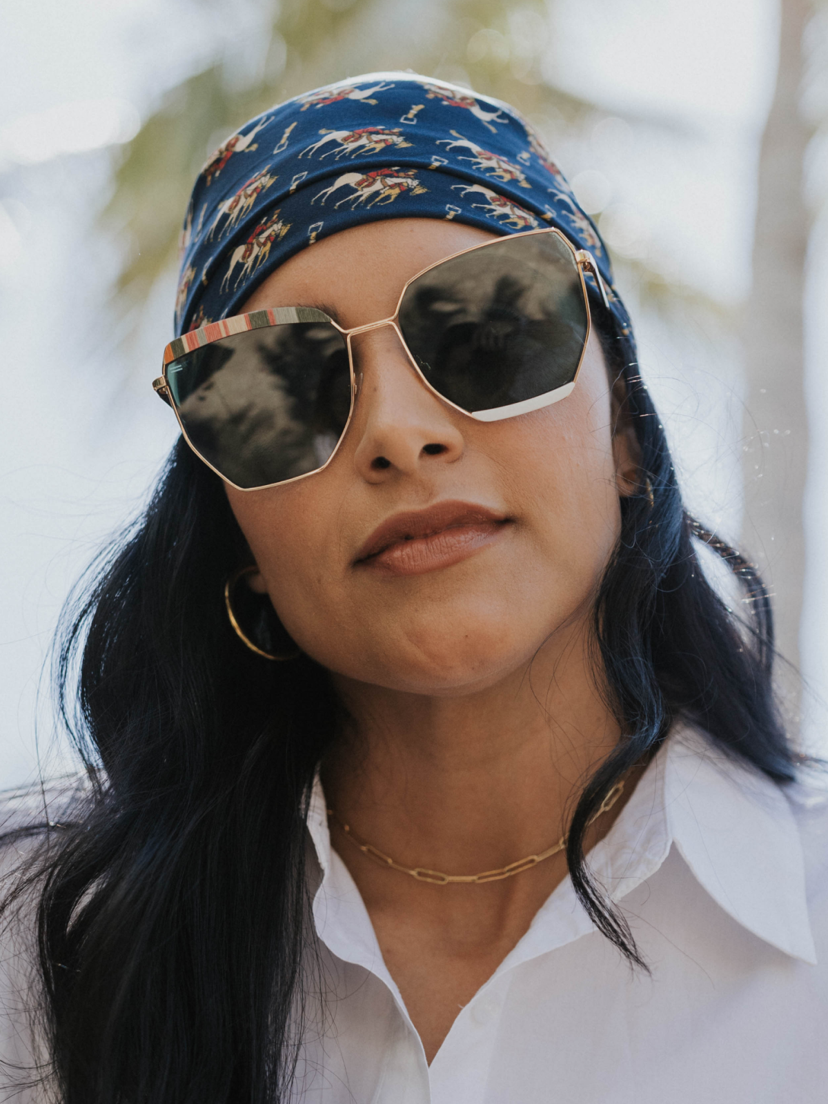 Venice sunglasses with recycled maple rainbow frames worn outdoors on Worth Avenue in Palm Beach