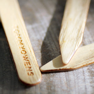 Ash Wood Collar Stays close up of logo and wood grain texture 