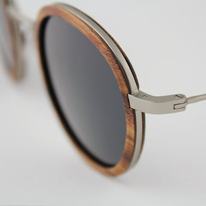 Pasco silver lightweight titanium and rosewood rimmed sunglasses up close